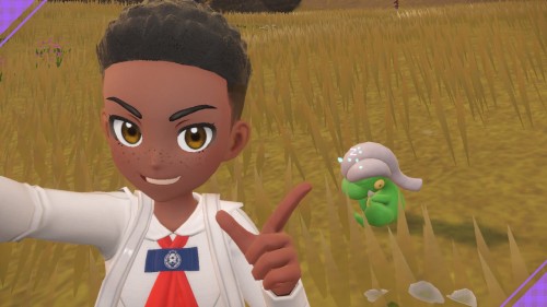 my character in Pokémon Violet, a young dark skinned black boy with a curly hi-top, posing with a shiny dragon Pokémon called Bagon