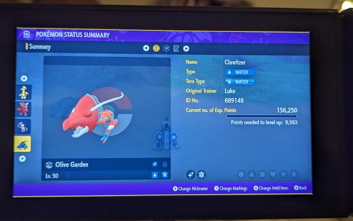 The Pokémon summary screen for my shiny Clawitzer. It is a crustacean Pokémon that resembles a bright red shrimp. Its body is divided into several segments by black ridges and there are three small spikes behind its head. It has semicircular, yellow eyes, a black stripe across its face divided into parts, and four pointed mandibles.
